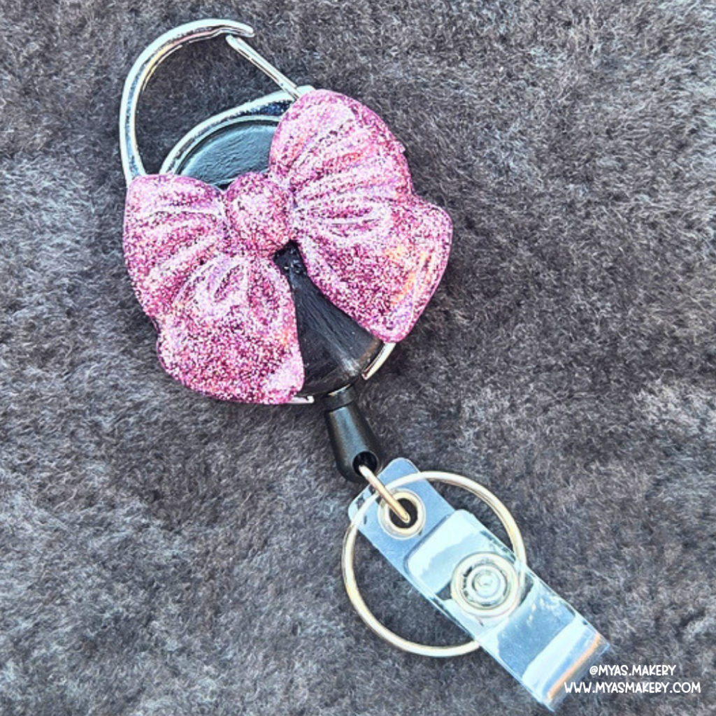 Diva Dust Bow badge reel